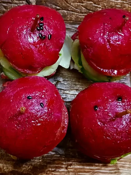 Adorable and delicious mini beetroot sliders. The naturally pink buns are gluten-free, made from millet, and filled with an aloo tikki patty.