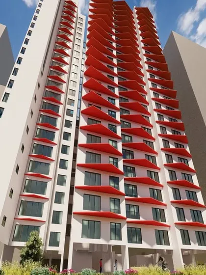 A different perspective of the experimental facade with red angled shades. This low-angle view emphasizes the three-dimensional quality of the modules and how they interact with light and shadow to create a dynamic surface.