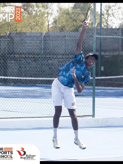 A player showcases a powerful serve during our 2023 Summer Camp. Our camps offer a comprehensive experience with expert coaching, world-class infrastructure, and fun recreational activities.