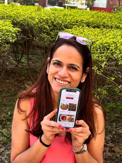 This is me, holding the app that holds my mission. I started Nivaala from a place of loss, but now it's about building a digital space where families can record, share, and document their culinary legacy together.