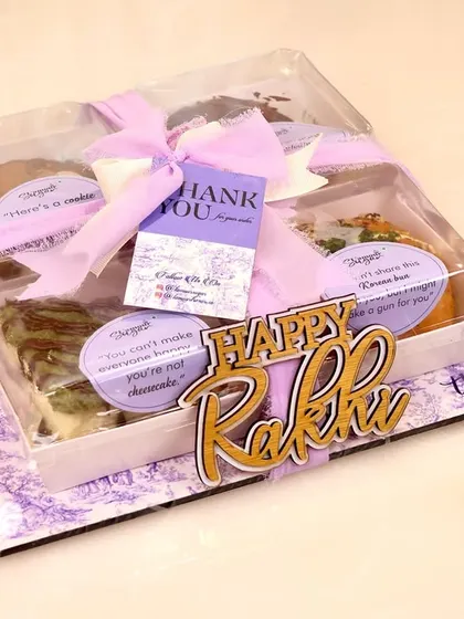 The final presentation of our Rakhi 'Party in a Box'. It comes with a custom 'Happy Rakhi' tag and is wrapped with a beautiful ribbon, making it a complete and impressive gift.