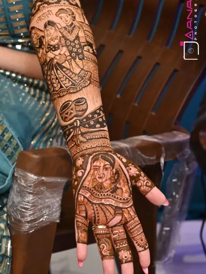 A single arm design featuring a bride's portrait on the palm and a couple's portrait on the forearm.