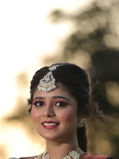 A close-up of the client's happy expression and traditional jewelry.