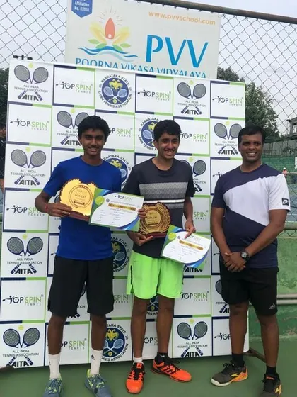 A final shot of the proud U-18 doubles champions with their coach.