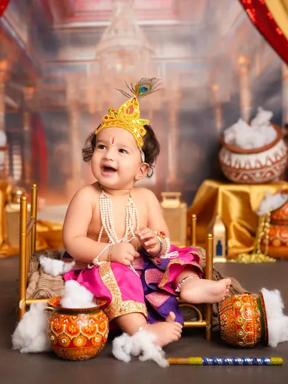 The joy and mischief of little Krishna captured perfectly. His happy expression and the traditional props make this a lively and delightful photograph.