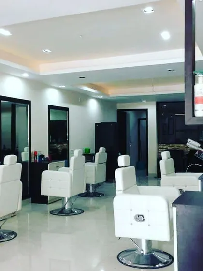 Here is a completed salon project with a clean, bright, and airy feel. The all-white styling chairs, simple large mirrors, and warm overhead lighting create a very welcoming and professional space.