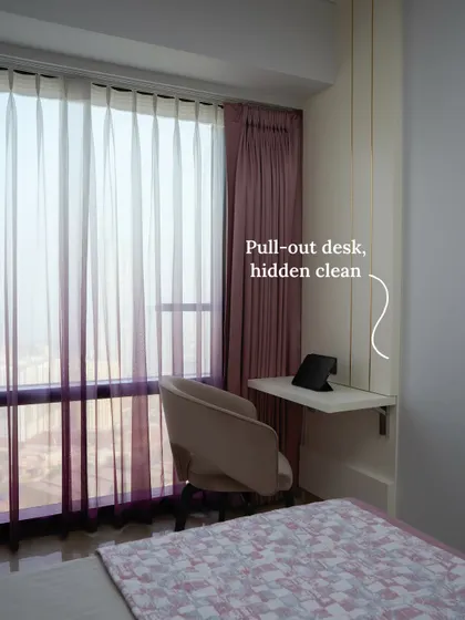 This pull-out desk in a guest room is a space-savvy solution that folds away neatly, keeping the bedroom open and distraction-free when not in use.