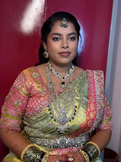 For Chaitra's reception, we went with a soft glam look to complement her beautiful pastel saree and diamond jewelry.