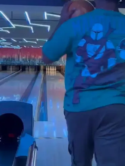 A glimpse from our bowling league, with a player in a Mandalorian t-shirt getting ready to bowl.