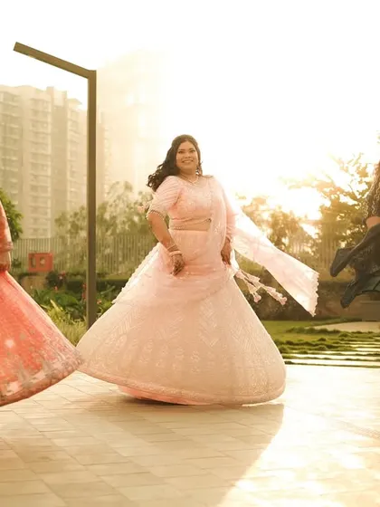 The bridesmaids enjoying a fun, synchronized twirl in the sunlight, a great shot of the bride's tribe.