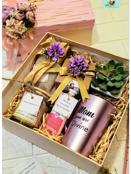 A thoughtful gift for your mom or mom-in-law. This pamper hamper includes a 'Mom you are Divine' mug, a succulent, a hand-poured soy candle, and other treats.