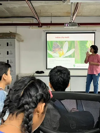 At the National Centre for Biological Sciences (NCBS), children attend a presentation on the Indian Lily Moth, learning from real scientists in a research environment.