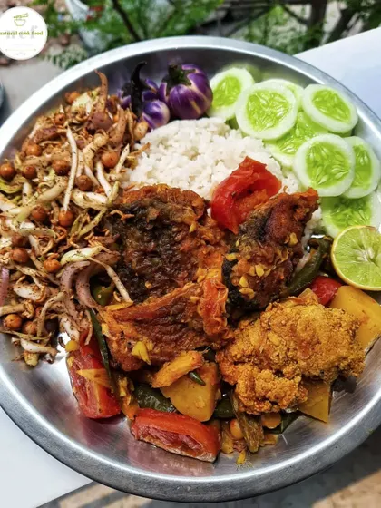 A simple plate of fried fish curry served with singju, fresh cucumbers, and other delicious items.