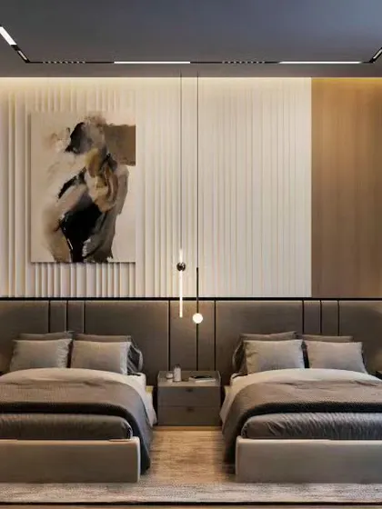 This twin guest room design exudes elegance with a full-length upholstered headboard and sophisticated pendant lighting. It's a welcoming and comfortable space for any visitors.