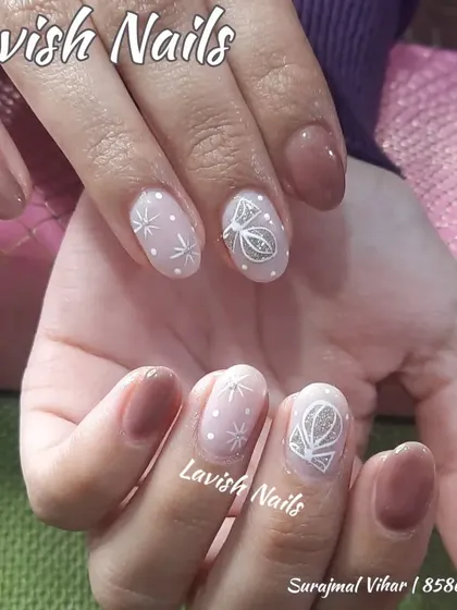 A delicate, winter-themed design with hand-painted white stars and a geometric pattern on a sheer, shimmery base.