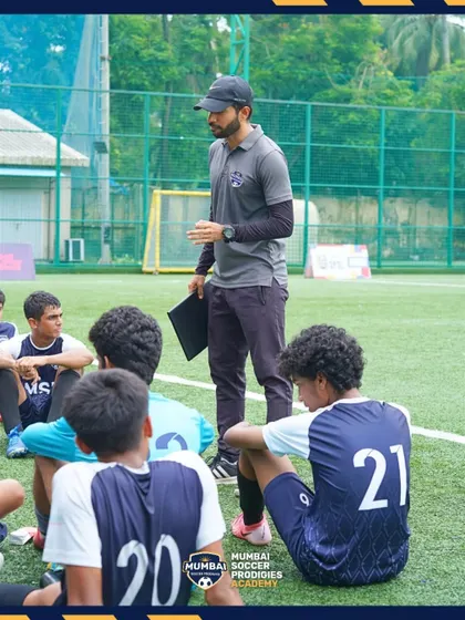 A coach debriefs the U17 team after their semi-final match, focusing on growth and learning.