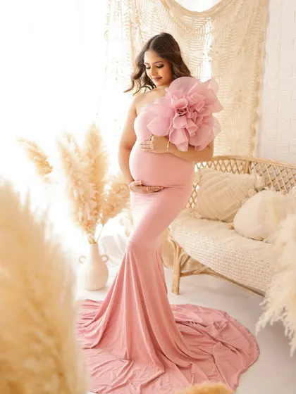 A duplicate of image 152, this stylish and modern portrait in a pink gown with a large floral detail is a true work of art.