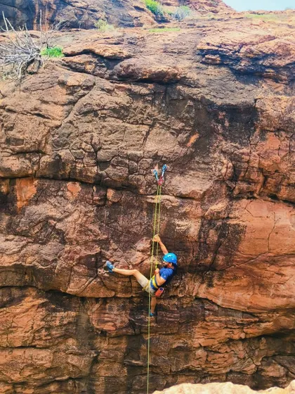 A participant practices an advanced technique, using ascenders on a fixed rope.