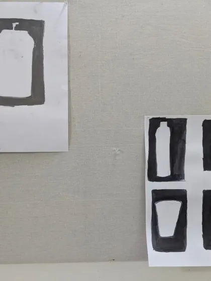 Close-up of student work exploring negative space. These studies of bottles and glasses help build a strong foundation in understanding positive and negative shapes in a composition.