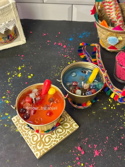 A vibrant flat-lay of my Holi-themed bucket candles. The bright colors and playful design, inspired by buckets of colored water, make these a perfect, unique gift for any Holi party.