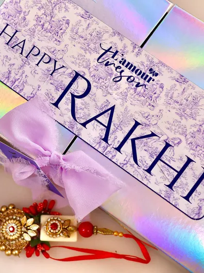 Our iridescent Rakhi gift box, paired with a beautiful rakhi, ready to be gifted. The packaging is designed to be as special as the treats inside.