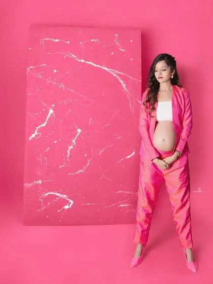 A final look at this incredible pink suit, showcasing a confident and stylish pose. This is for the moms who want to break the mold of traditional maternity photos.