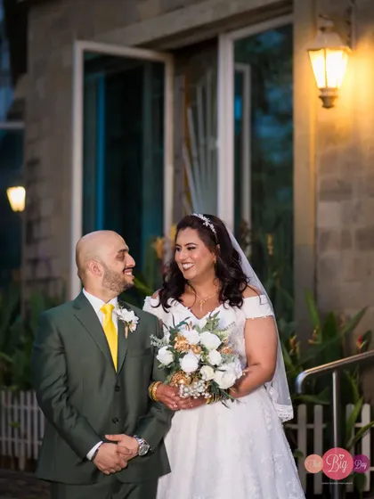 Anthony and Nixie share a happy moment after their church wedding, the bride holding her beautiful bouquet.