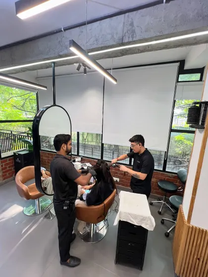 Two of my stylists collaborating on a client's hair. This teamwork ensures precision and a perfect result, especially for more complex treatments.