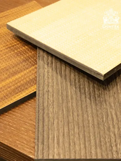 A simple, elegant shot of three different veneer samples. You can see a light woven texture, a classic wood grain, and a darker, linear pattern.