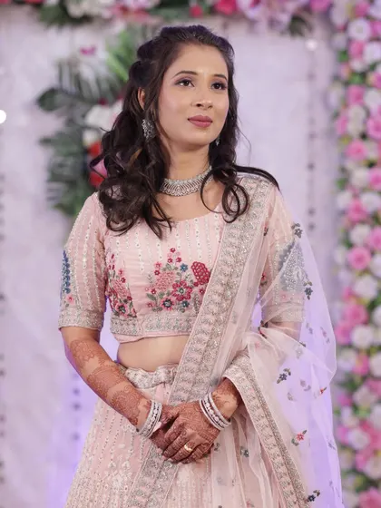 A soft and pretty look in a pastel pink lehenga. The makeup is fresh and youthful, perfect for a sangeet or reception.