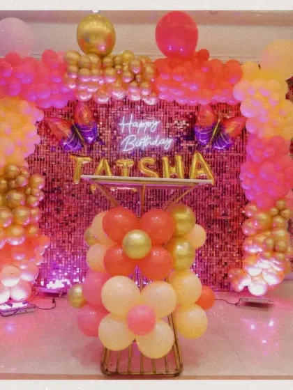 The birthday decor and photo backdrop for Taisha's party. The balloon arch and neon sign create a perfect spot for memorable photos.
