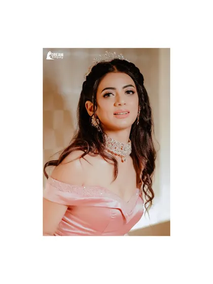 A lovely portrait of bride Priya in her pink off-shoulder gown and tiara, looking like a modern-day princess for her Sagan ceremony.
