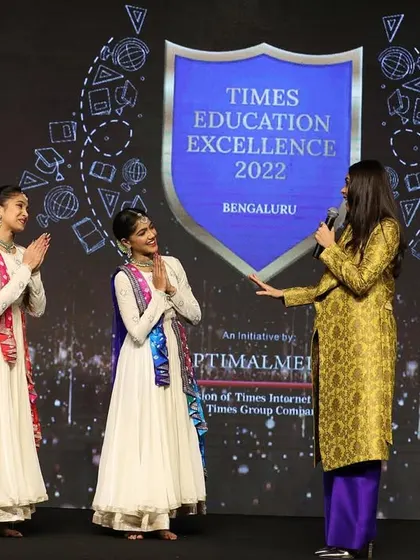 Interacting with the host on stage at the Times Education Excellence awards. Performing at such prestigious corporate events allows us to share our art with a diverse audience.