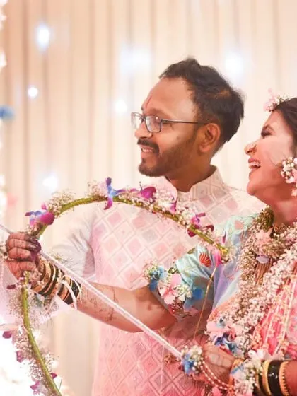 A fun moment from a baby shower where the couple is playing a game. The mom-to-be is wearing a full set of our colourful floral jewellery.