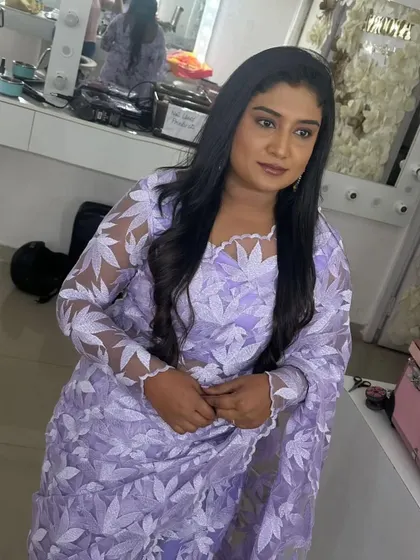 A client looking elegant in a lavender floral applique saree, perfect for a sophisticated party look.