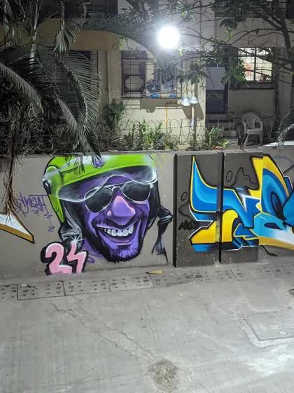 The finished character piece on the street, right next to some classic graffiti lettering.