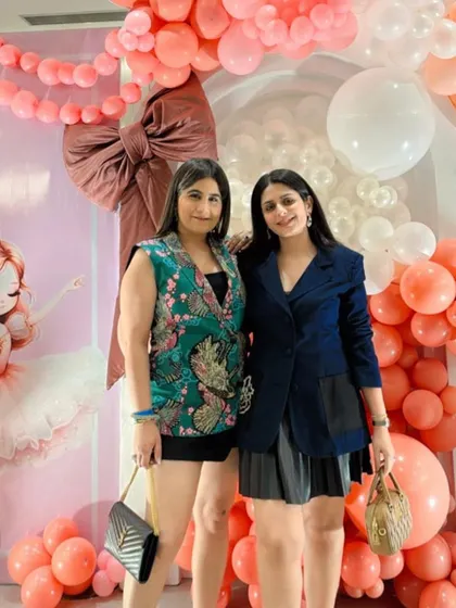 Two guests enjoying the party and posing for a picture.