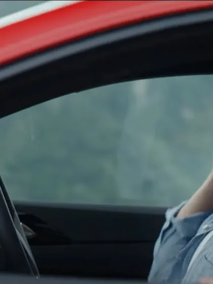 Another shot of the couple enjoying their drive. The simple, classic styling ensures the focus is on their connection and the driving experience.