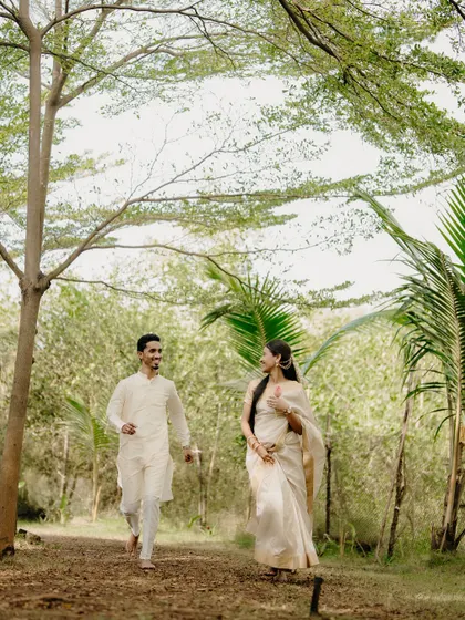 A playful chase through the woods. Dressed in traditional attire, their laughter and movement bring a lighthearted energy to this heritage-themed shoot.