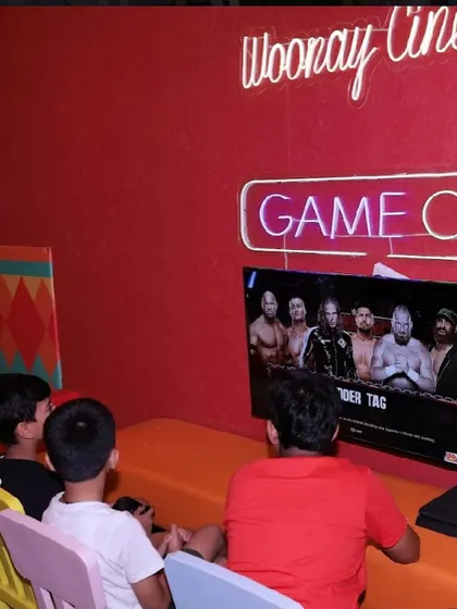 A group of boys enjoying a video game session in our comfortable and private cinema room.