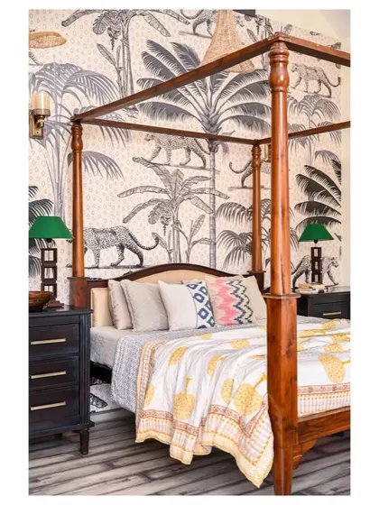 A four-poster bed is a timeless classic. In this master bedroom, we paired it with a dramatic black and white jungle-themed wallpaper and dangling bamboo lamps to fill the 20-foot high ceiling space.