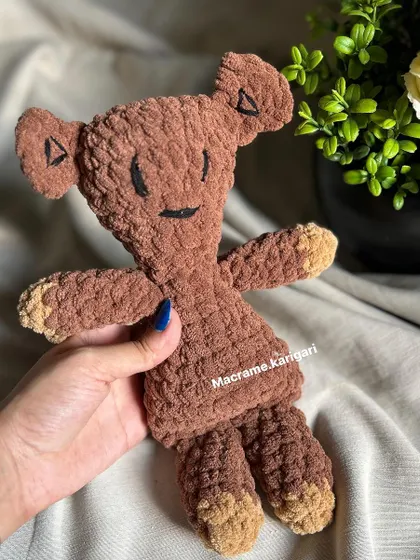 Holding our handmade Mr. Bean's Teddy. It’s a joy to create toys that bring back such fond memories for so many people. This amigurumi is a simple, heartfelt piece that captures the essence of a beloved character.