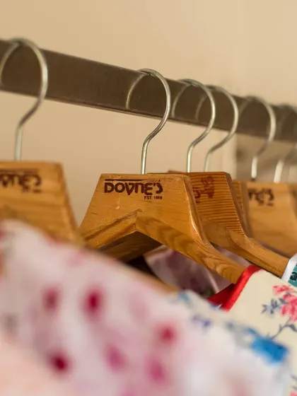 Another view of my hangers, holding a variety of colorful printed dresses ready for their new homes.