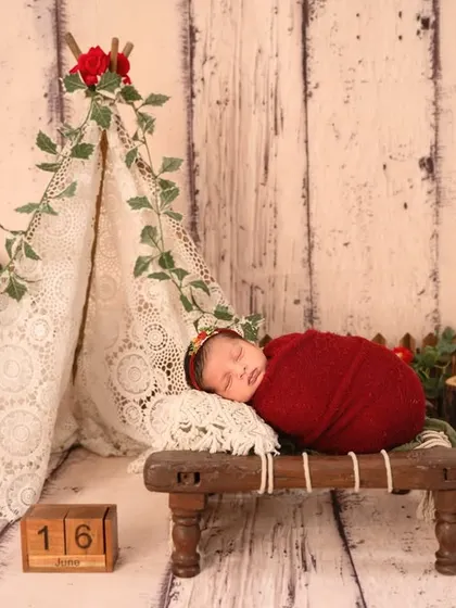For the adventurous family, this little camper theme with a lace teepee, rustic wood, and pops of red is a wonderfully unique and charming choice.