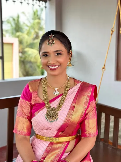 A smiling portrait of Sneha on her engagement day. The makeup is fresh and bright, perfect for celebrating this happy occasion.
