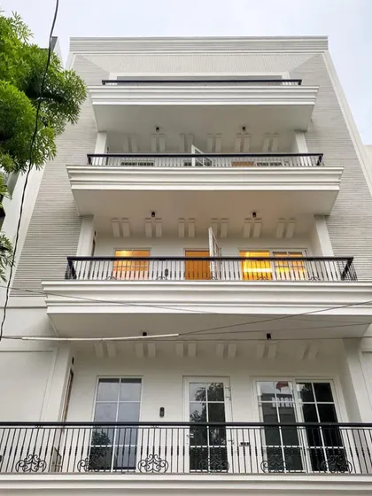 This is the facade of our C-926 property in Sushant Lok 1. The white elevation with classic balconies and large windows creates a look of modern, understated luxury.