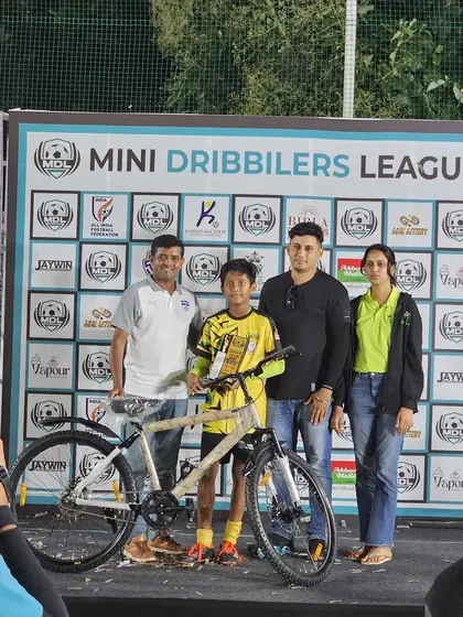 Abhay on the presentation stage with his family and his awards at the Mini Dribblers League.