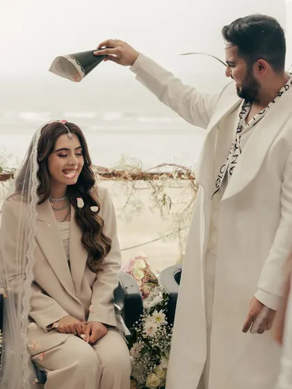 A playful moment during their beach ceremony. These lighthearted, fun interactions are just as important as the solemn vows, as they show the true personality of the couple.