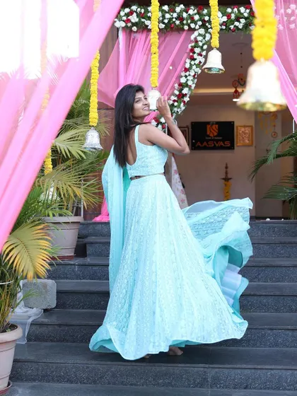 This is the same beautiful shot from the designer studio apparel shoot, highlighting the flowing fabric and intricate details of the light blue lehenga.