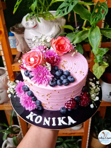 A beautiful floral cake is always a good idea. This design is loaded with fresh flowers and berries, creating a vibrant and lush look that's perfect for any celebration.